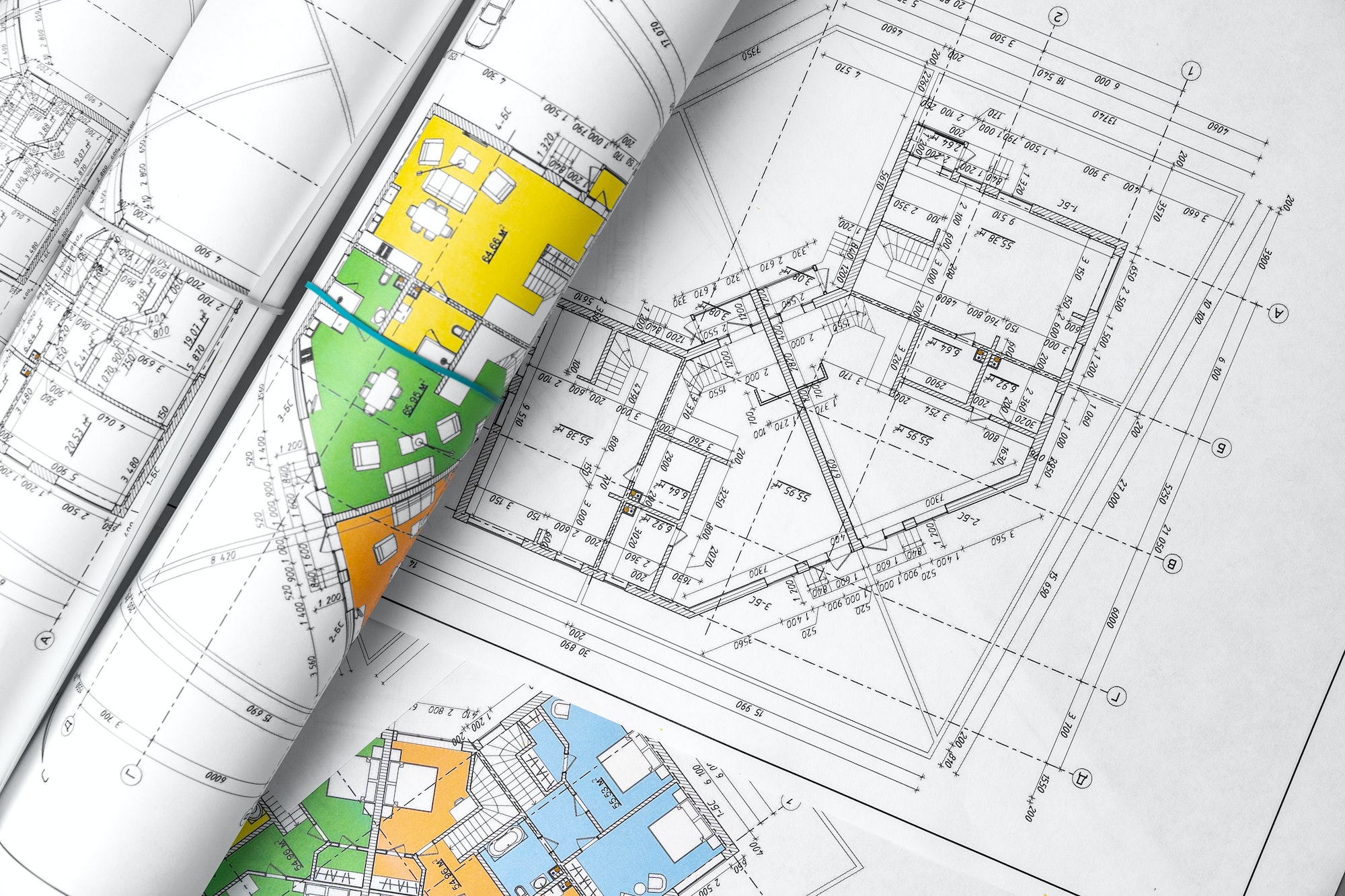 Architectural construction plans paper on table close up